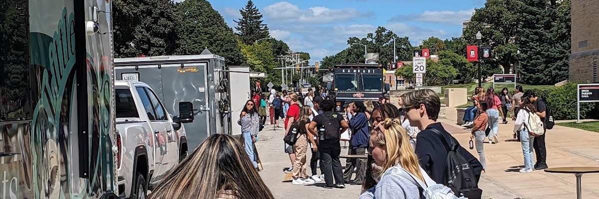 Students wait in line at various food trucks for Food Truck Wednesdays on campus.